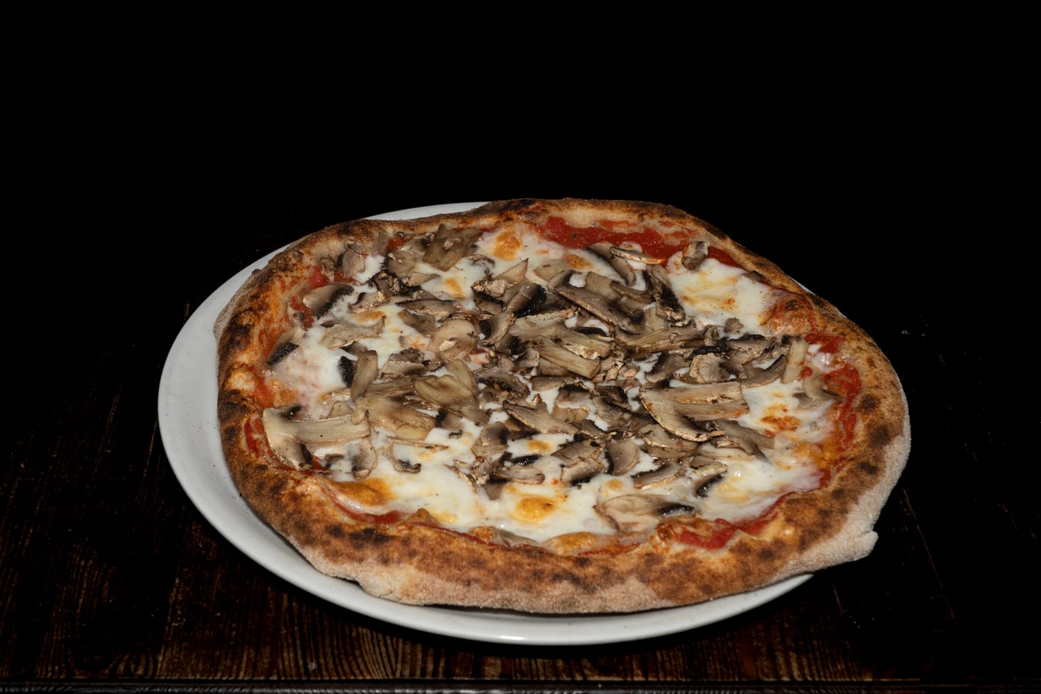 Pizza ai Funghi artigianale con base di pomodoro e fior di latte, ricoperta da una generosa dose di funghi freschi affettati e cotta in forno a legna — Pizzeria Alla Botte, Misilmeri.