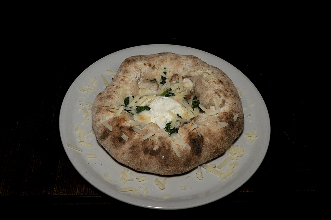 Pizza Ciambella a Misilmeri con bordo ripieno di ricotta, guarnita con fior di latte, spinaci, funghi porcini e scaglie di grana — Pizzeria Alla Botte.
